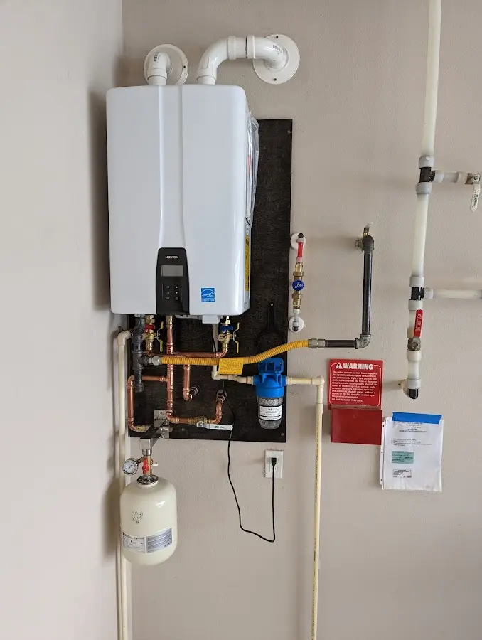 Professional plumber installing copper piping in a Livonia home